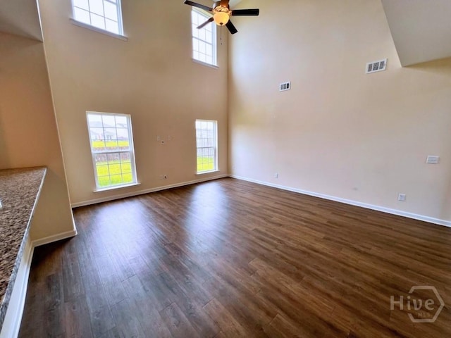 125 Grimsby Rd, Savannah, GA 31407 - unfurnished living room with a high ceiling, dark wood-style flooring, a ceiling fan, and baseboards