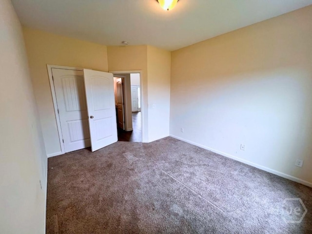 125 Grimsby Rd, Savannah, GA 31407 - unfurnished bedroom with dark colored carpet, baseboards, and a closet