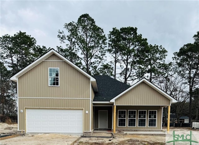 traditional home featuring concrete driveway and roof with shingles