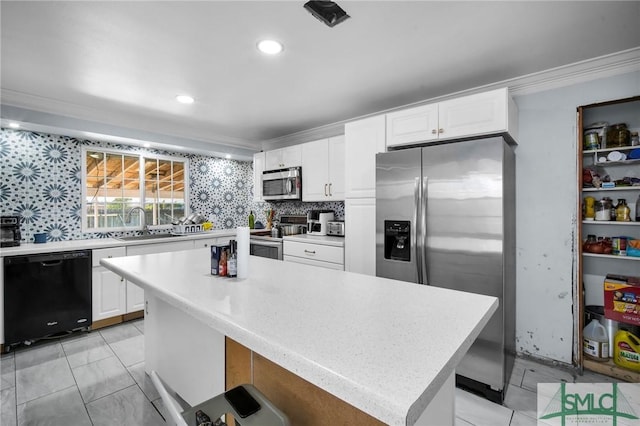 kitchen featuring a kitchen island, sink, white cabinets, decorative backsplash, and stainless steel appliances