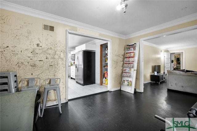 interior space featuring crown molding and light hardwood / wood-style floors