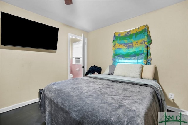 bedroom with ceiling fan, cooling unit, and ensuite bath