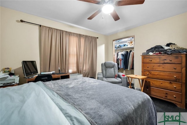 bedroom featuring a spacious closet, a closet, and ceiling fan