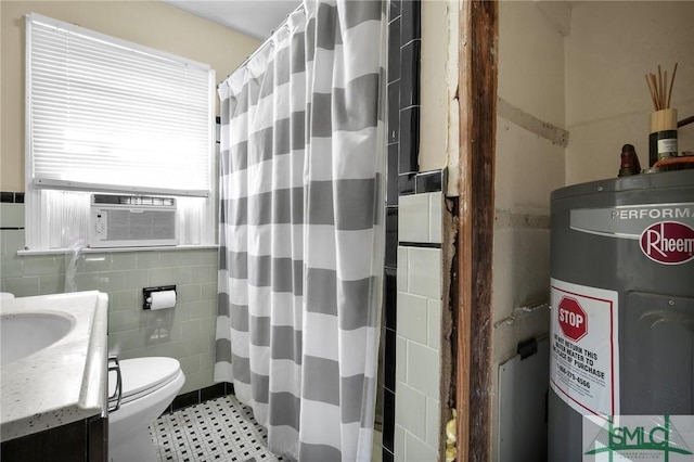 bathroom featuring tile walls, cooling unit, vanity, toilet, and electric water heater