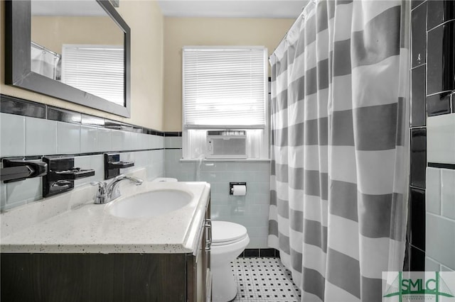 bathroom featuring cooling unit, tile walls, vanity, toilet, and a shower with shower curtain