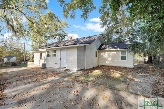 rear view of property with a patio area and central air condition unit