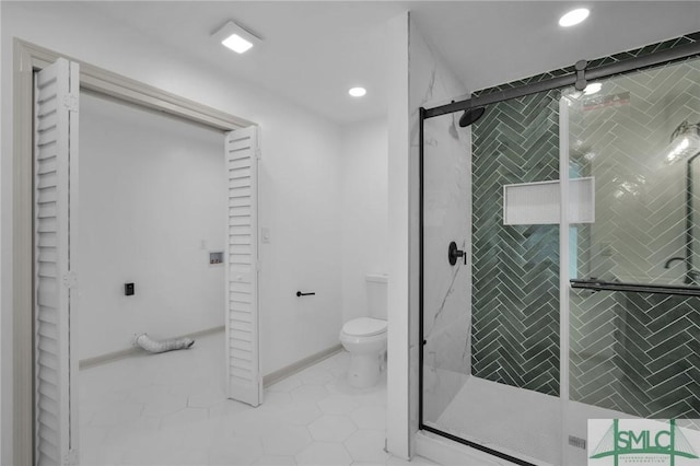 bathroom with a shower with door, tile patterned floors, and toilet