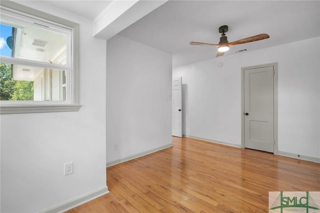 spare room with ceiling fan, ornamental molding, and light hardwood / wood-style floors