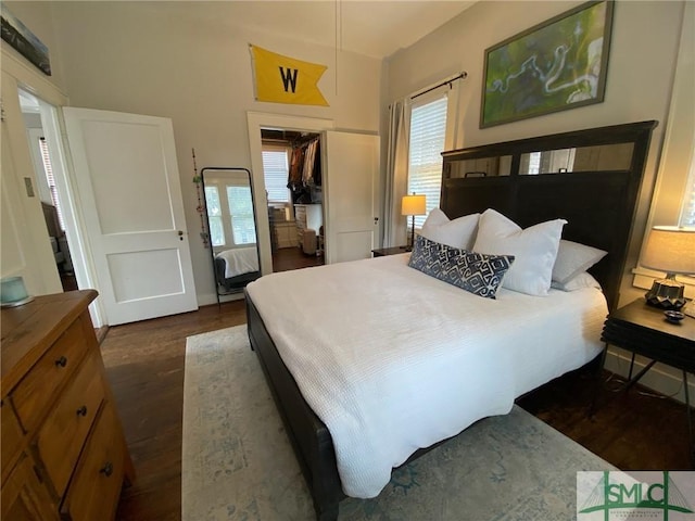 bedroom featuring dark wood-type flooring and a closet