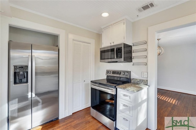 kitchen featuring crown molding, appliances with stainless steel finishes, white cabinets, and dark hardwood / wood-style flooring