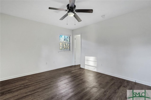 spare room featuring dark hardwood / wood-style floors and ceiling fan