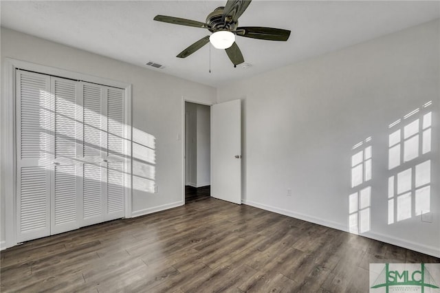 unfurnished bedroom featuring dark hardwood / wood-style flooring and ceiling fan