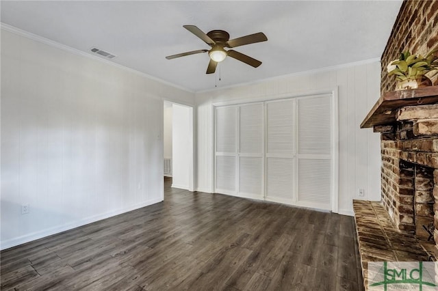 unfurnished living room featuring ornamental molding, dark hardwood / wood-style flooring, and a brick fireplace