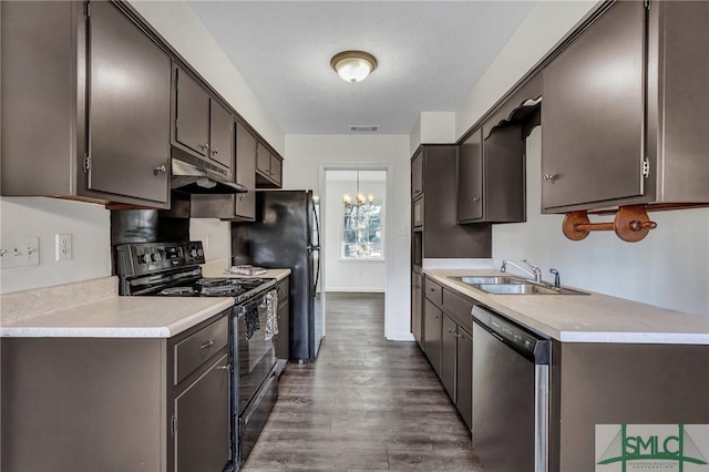 kitchen featuring dark brown cabinetry, sink, wood-type flooring, stainless steel dishwasher, and black range with electric stovetop