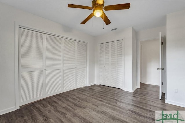 unfurnished bedroom with dark hardwood / wood-style floors and ceiling fan