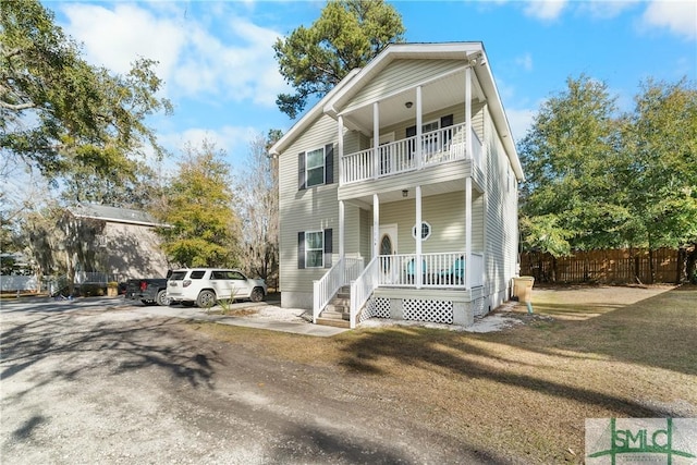 view of front of home featuring a porch and a balcony