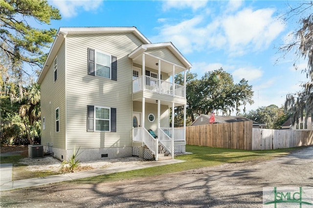 view of front facade featuring cooling unit, a balcony, and covered porch