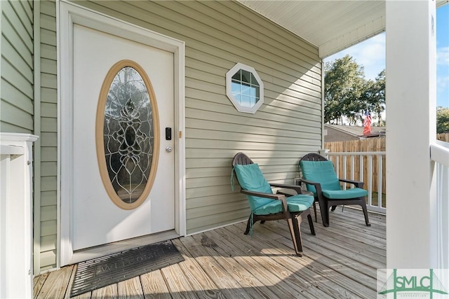 view of exterior entry featuring covered porch