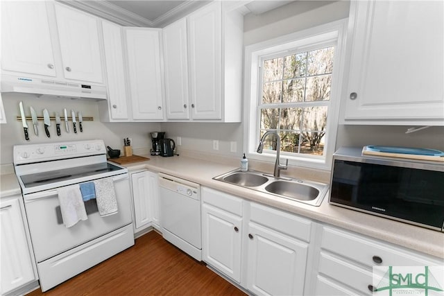 kitchen with dark hardwood / wood-style flooring, sink, white cabinets, and white appliances