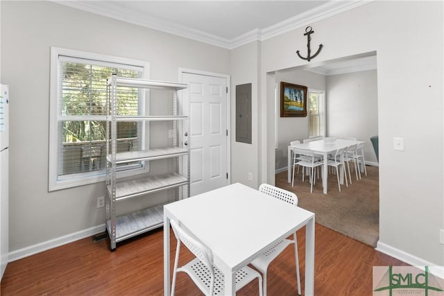 dining area featuring crown molding, electric panel, and hardwood / wood-style floors