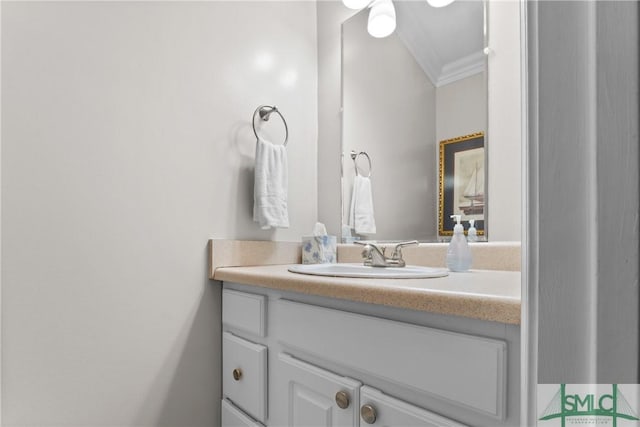 bathroom with ornamental molding and vanity