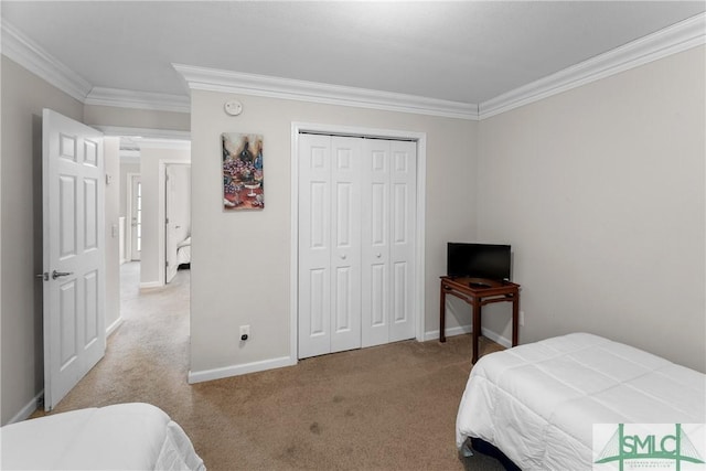 carpeted bedroom featuring ornamental molding and a closet