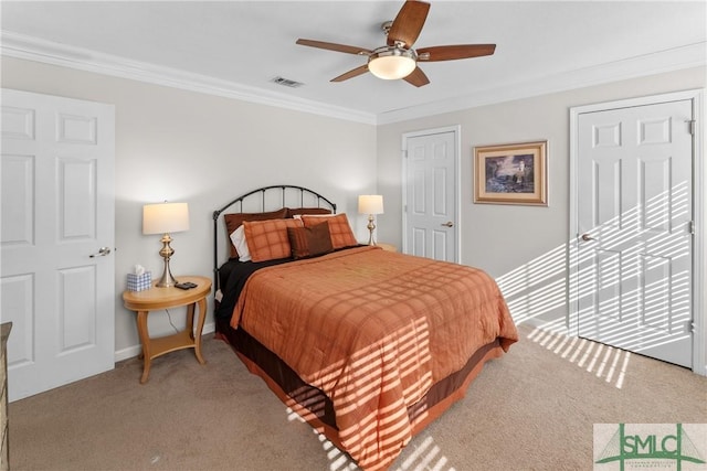 bedroom with crown molding, ceiling fan, and carpet flooring