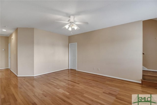 empty room with ceiling fan and light hardwood / wood-style floors