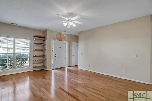 unfurnished room with ceiling fan and light hardwood / wood-style flooring