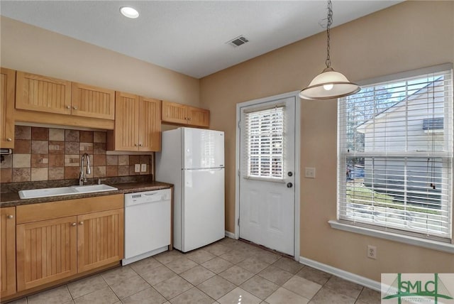 kitchen featuring light tile patterned flooring, sink, hanging light fixtures, white appliances, and decorative backsplash