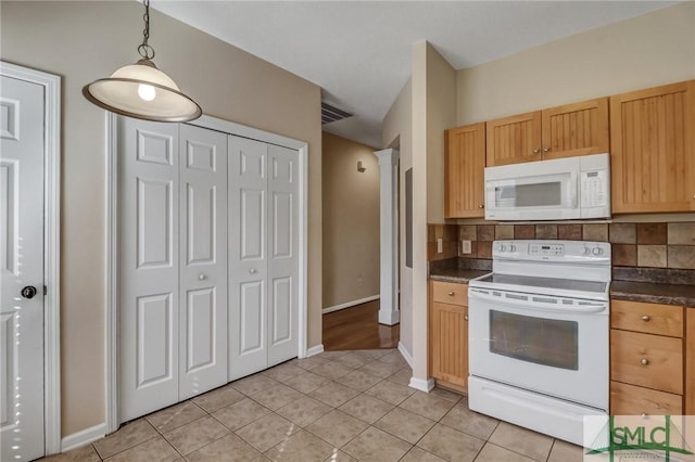 kitchen with tasteful backsplash, hanging light fixtures, light tile patterned floors, white appliances, and decorative columns