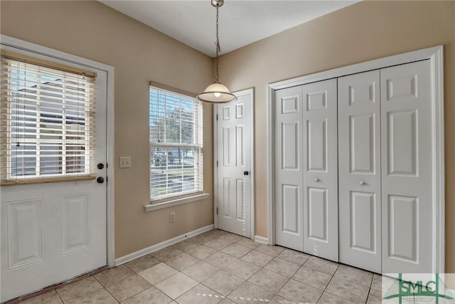 doorway to outside with light tile patterned floors