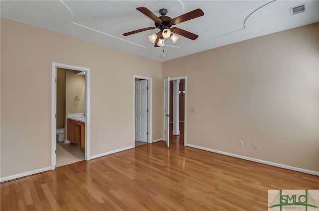 unfurnished bedroom with ceiling fan, connected bathroom, and light hardwood / wood-style flooring