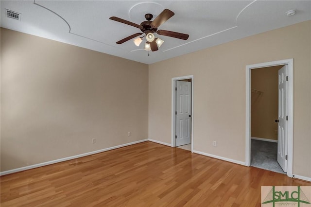 empty room featuring ceiling fan and hardwood / wood-style floors