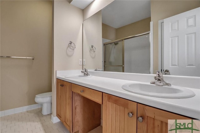 bathroom with vanity, tile patterned floors, toilet, and walk in shower