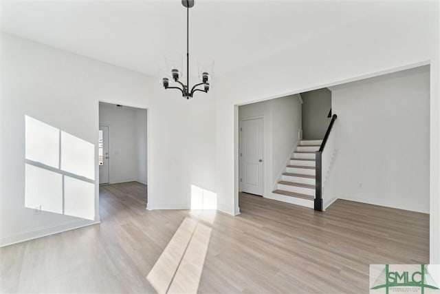 interior space featuring a notable chandelier and light wood-type flooring