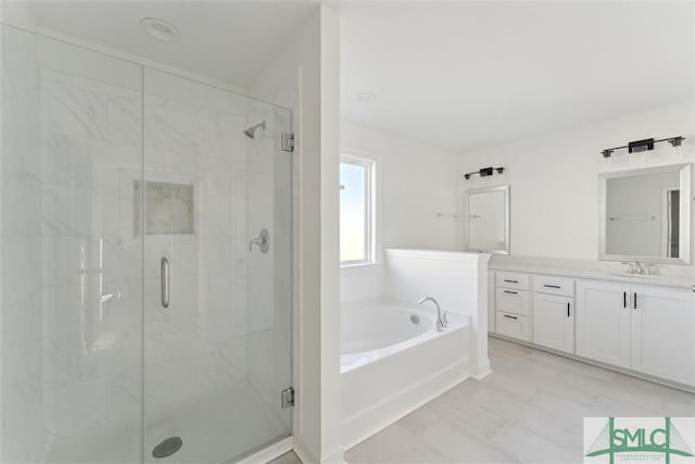 bathroom featuring vanity and separate shower and tub