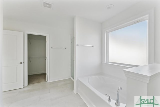 bathroom featuring separate shower and tub