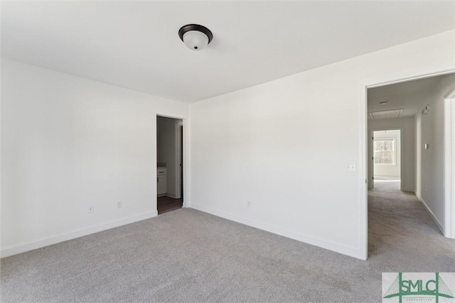 unfurnished room featuring light colored carpet