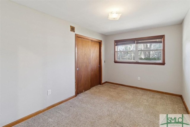 unfurnished bedroom featuring a closet and carpet flooring