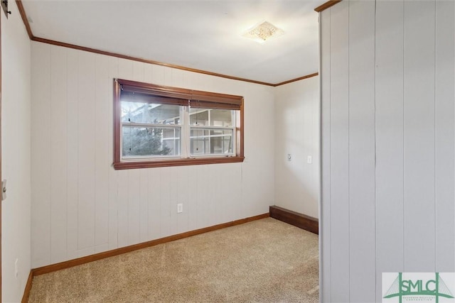 carpeted spare room with crown molding