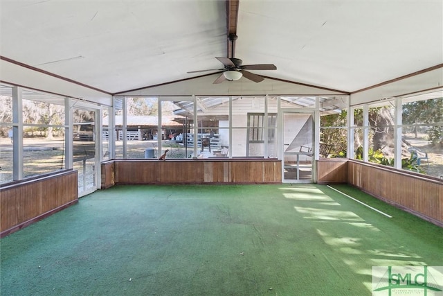 unfurnished sunroom with ceiling fan, plenty of natural light, and vaulted ceiling with beams