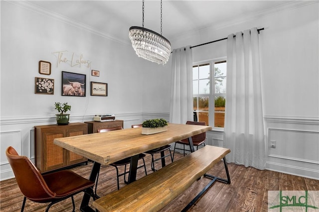 dining room with ornamental molding, dark hardwood / wood-style flooring, and a chandelier