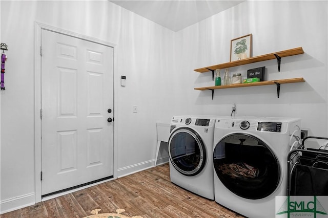 laundry area featuring hardwood / wood-style flooring and separate washer and dryer