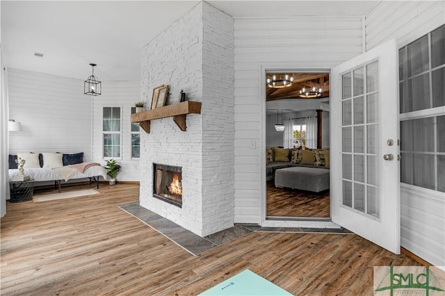 living room featuring hardwood / wood-style flooring and a stone fireplace