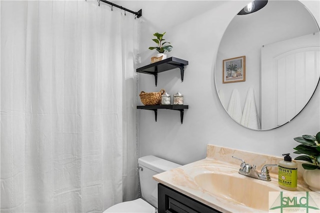 bathroom featuring vanity and toilet