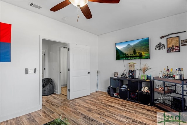 living room with hardwood / wood-style flooring and ceiling fan