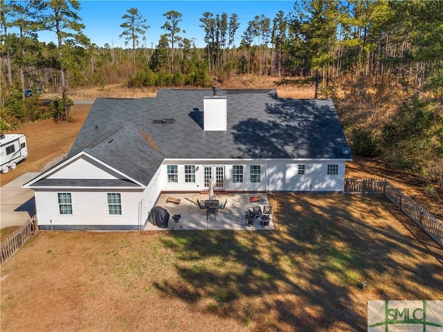 rear view of property with a yard and a patio area