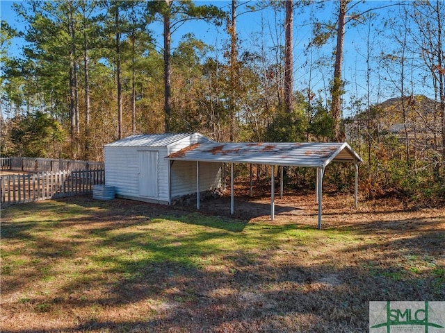 view of outdoor structure with a yard and a carport