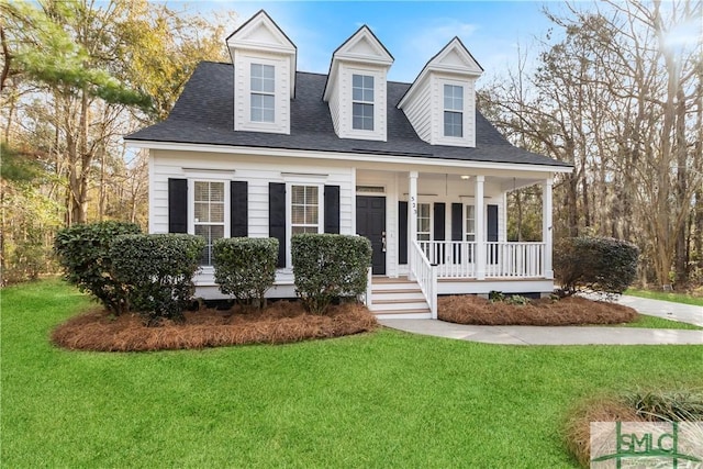 cape cod home with covered porch and a front lawn